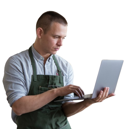 Handwerker mit Schürze arbeitet am Laptop. Digitales Arbeiten im Handwerk, Online-Business, Selbstständigkeit, moderne Arbeitsweise.